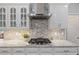 Well-appointed kitchen with a gas range, marble countertops, and modern vent hood at 96 Grand Ave, Suwanee, GA 30024