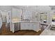 Well-lit kitchen island featuring marble countertops and stainless steel appliances, with yard views at 96 Grand Ave, Suwanee, GA 30024