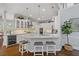 Bright kitchen with white cabinetry, marble countertops, and stainless steel appliances at 96 Grand Ave, Suwanee, GA 30024