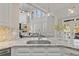 Bright kitchen with marble countertops, stainless steel sink, and breakfast area, with backyard access at 96 Grand Ave, Suwanee, GA 30024
