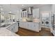 Modern kitchen featuring stainless steel appliances, marble countertops, and access to the laundry room at 96 Grand Ave, Suwanee, GA 30024