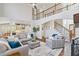 Spacious living room with open layout, modern staircase, and view of the eat-in kitchen at 96 Grand Ave, Suwanee, GA 30024