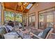 Inviting screened patio with comfortable seating, ceiling fan and wooded view at 96 Grand Ave, Suwanee, GA 30024