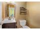 Powder room with single sink vanity and decorative shelving at 3979 Doral Cir, Atlanta, GA 30360