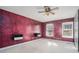 Spacious bedroom with dark-red walls, ceiling fan and lots of natural light at 3979 Doral Cir, Atlanta, GA 30360