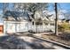 White two-story house with a wraparound porch and attached garage at 3979 Doral Cir, Atlanta, GA 30360