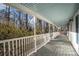 Spacious front porch with white railings and light blue ceiling at 3979 Doral Cir, Atlanta, GA 30360