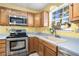 Kitchen with yellow walls, wood cabinets, and a large window at 3979 Doral Cir, Atlanta, GA 30360