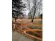 Landscaped backyard with wooden fence and mature trees at 4045 Mark Todd Ct, Hoschton, GA 30548