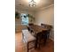 Dining room with wood table, bench, and hardwood floors at 4045 Mark Todd Ct, Hoschton, GA 30548