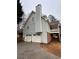 Two-car garage and gray siding with a brick base at 4045 Mark Todd Ct, Hoschton, GA 30548