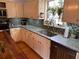 Kitchen with granite countertops, stainless steel sink, and white cabinets at 4045 Mark Todd Ct, Hoschton, GA 30548