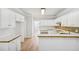 Spacious kitchen featuring white cabinets, hardwood floors, and laminate countertops at 3045 Wyntree Dr, Peachtree Corners, GA 30071