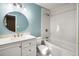 Bathroom with a large vanity, tub, and circular mirror at 1801 Se Caribaea Se Trl, Atlanta, GA 30316