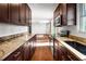 Modern kitchen features granite countertops and dark brown cabinets at 1801 Se Caribaea Se Trl, Atlanta, GA 30316