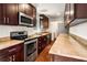 Modern kitchen with dark cabinetry and granite countertops at 1801 Se Caribaea Se Trl, Atlanta, GA 30316