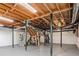Unfinished basement with exposed ceiling offers a versatile space for storage or customization at 620 Oakstone Way, Roswell, GA 30075