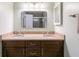 Bathroom with double vanity, granite counters, and updated fixtures offers a modern aesthetic at 620 Oakstone Way, Roswell, GA 30075