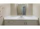 Bathroom vanity featuring a large mirror, white countertops and cabinets at 620 Oakstone Way, Roswell, GA 30075