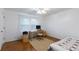 Bright bedroom with hardwood floors, featuring a work station and ample natural light at 620 Oakstone Way, Roswell, GA 30075