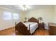 Warm bedroom featuring a wood bed frame and hardwood floors at 620 Oakstone Way, Roswell, GA 30075