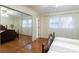 Bedroom features hardwood floors, large mirrored closet, and a sun-filled window at 620 Oakstone Way, Roswell, GA 30075