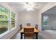 Bright dining area features trim, large windows, and a classic wooden table and chairs at 620 Oakstone Way, Roswell, GA 30075