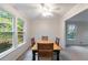 Dining room with hardwood floors, wood table and chairs, and large windows at 620 Oakstone Way, Roswell, GA 30075