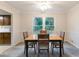 Bright dining room features a table with four chairs and large windows at 620 Oakstone Way, Roswell, GA 30075