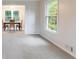 Spacious dining room with carpeted floor and view to the kitchen at 620 Oakstone Way, Roswell, GA 30075