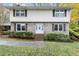 Brick two-story house with well-manicured landscaping and a welcoming front porch at 620 Oakstone Way, Roswell, GA 30075