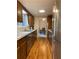 Galley-style kitchen with wood cabinets, stainless steel appliances, and a window over the sink at 620 Oakstone Way, Roswell, GA 30075