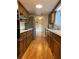 Galley kitchen with wood cabinets, stainless steel appliances, and hardwood floors at 620 Oakstone Way, Roswell, GA 30075