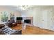 Living room with hardwood floors, fireplace, and a ceiling fan at 620 Oakstone Way, Roswell, GA 30075