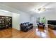 Spacious living room with hardwood floors, ceiling fan and built-in bookcase at 620 Oakstone Way, Roswell, GA 30075