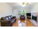 Living room featuring hardwood floors, fireplace and large windows at 620 Oakstone Way, Roswell, GA 30075