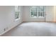 Spacious living room boasts soft neutral carpet, bright natural light, and a fresh, clean aesthetic at 620 Oakstone Way, Roswell, GA 30075