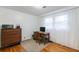 Home office with wood desk and chair, dresser, and hardwood floors at 620 Oakstone Way, Roswell, GA 30075