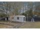 White shed with stone pathway and raised garden beds at 97 Grayson New Hope Rd, Grayson, GA 30017