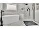 Luxurious bathroom with a soaking tub, a walk-in shower, and marble accents at 97 Grayson New Hope Rd, Grayson, GA 30017