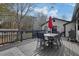 Outdoor deck area perfect for entertaining with black metal furniture, charcoal grill, and red patio umbrella at 97 Grayson New Hope Rd, Grayson, GA 30017