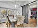 Bright dining room featuring a modern table, patterned chairs, and a sliding barn door at 97 Grayson New Hope Rd, Grayson, GA 30017