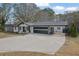 Modern white house with a two-car garage and a covered carport at 97 Grayson New Hope Rd, Grayson, GA 30017