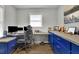 Functional home office with built-in desk and blue cabinets at 97 Grayson New Hope Rd, Grayson, GA 30017