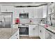 Modern white kitchen with stainless steel appliances and granite countertops at 97 Grayson New Hope Rd, Grayson, GA 30017