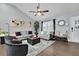 Modern living room with gray sofas, a large TV, and hardwood floors at 97 Grayson New Hope Rd, Grayson, GA 30017