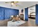 Cozy sitting area with blue accent wall, comfortable sofa, and barn doors at 97 Grayson New Hope Rd, Grayson, GA 30017