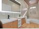 Modern bathroom with double vanity, bathtub, and wood-look floors at 1337 Fairfield Dr, Lilburn, GA 30047