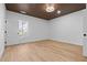 Simple bedroom with wood-look floors and a window with natural light at 1337 Fairfield Dr, Lilburn, GA 30047