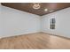 Bright bedroom with wood-look floors, recessed lighting, and a window at 1337 Fairfield Dr, Lilburn, GA 30047